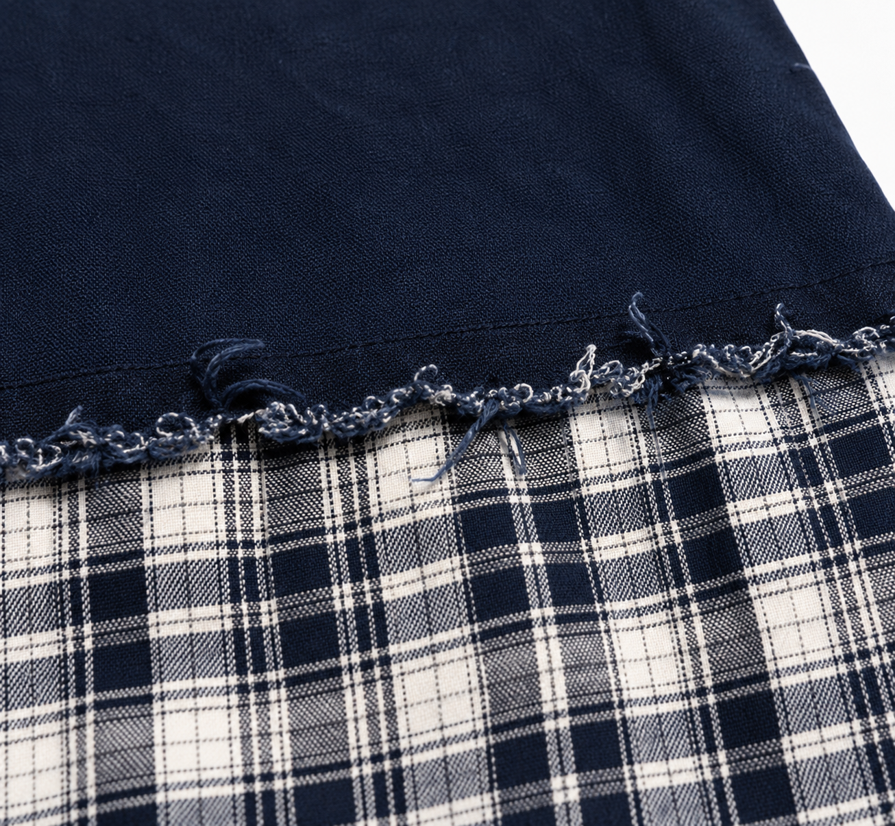 Distressed raw edge seam on enzyme wash patchwork shirt