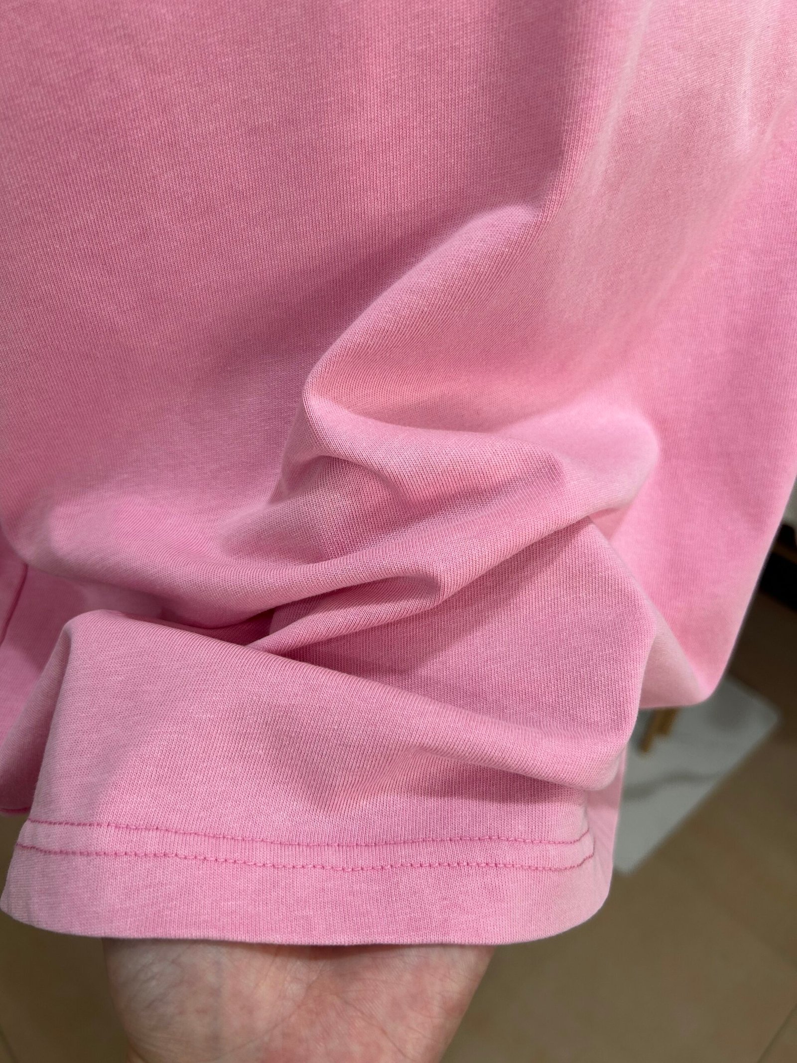 Pink fabric close up showing a natural vintage faded finish after salt washing